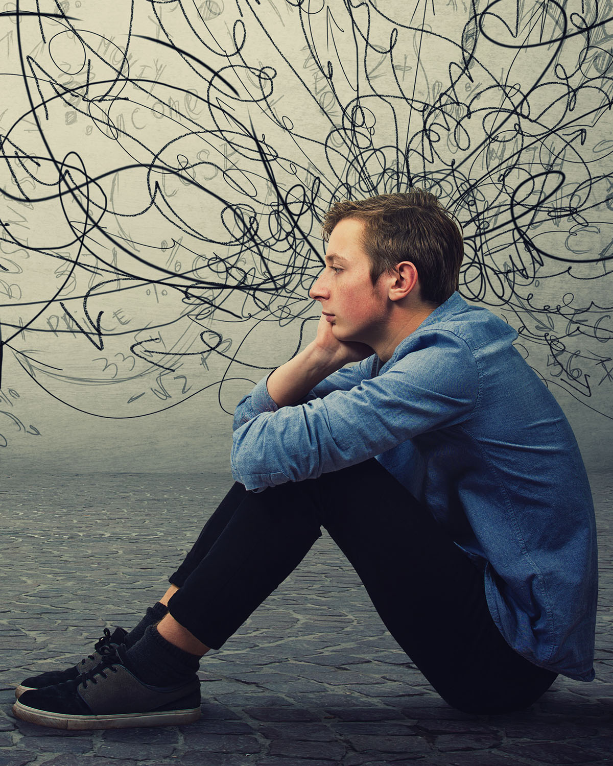 Young man sitting on the floor looking stressed and hopeless